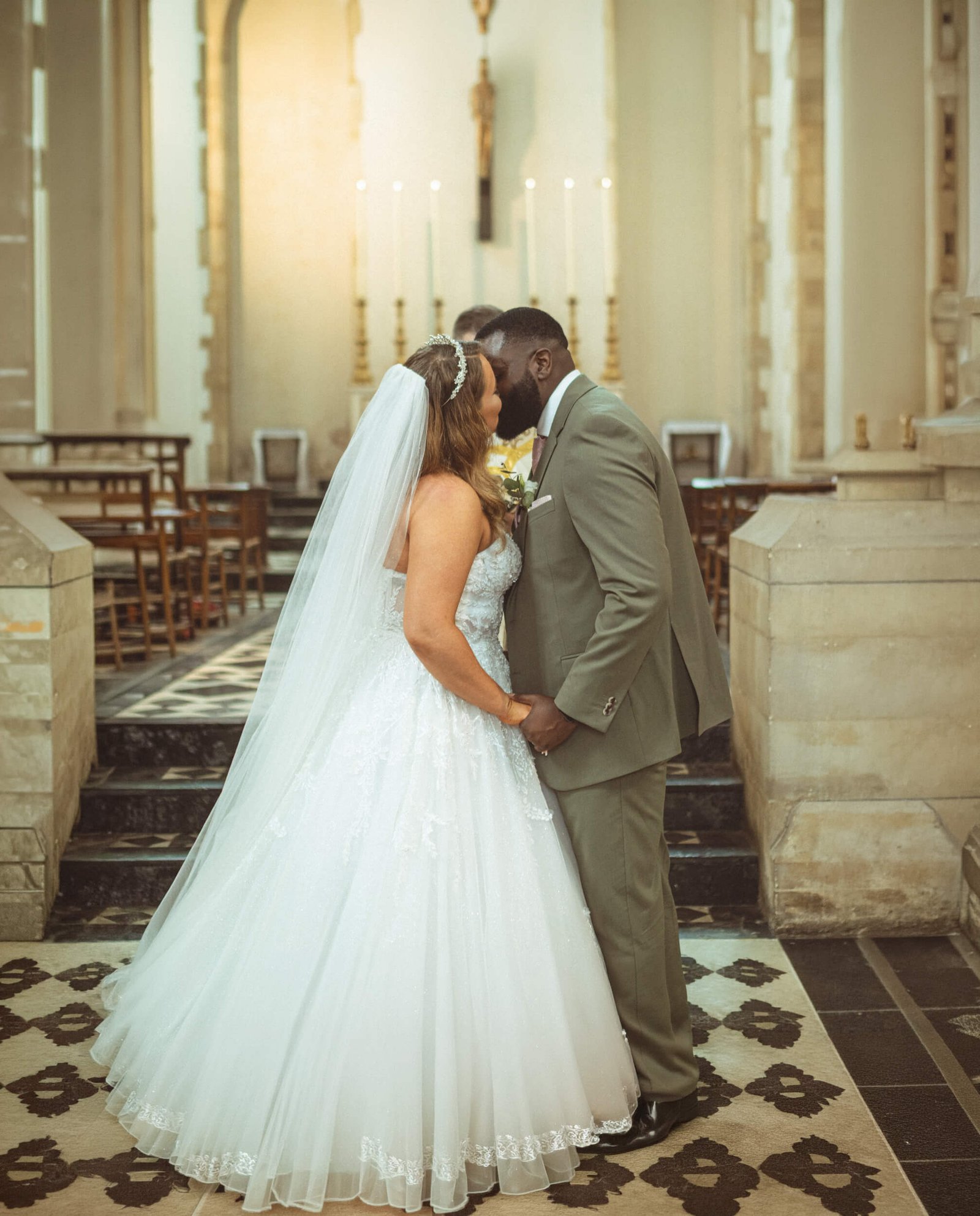 Bride and groom sharing a kiss during their church wedding